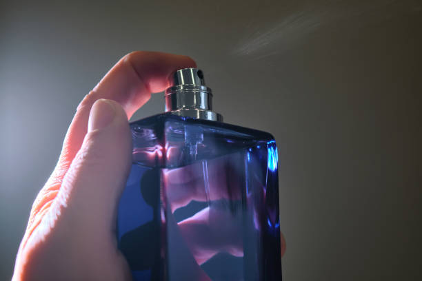 Hand spraying blue perfume bottle, emphasizing the benefits of wearing fragrance to bed.